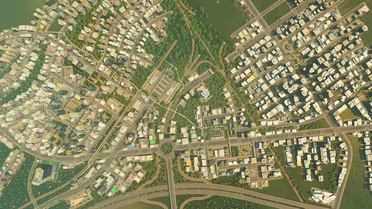 Una panoramica dall'alto di una fitta rete cittadina con strade, edifici residenziali e commerciali in Cities: Skylines